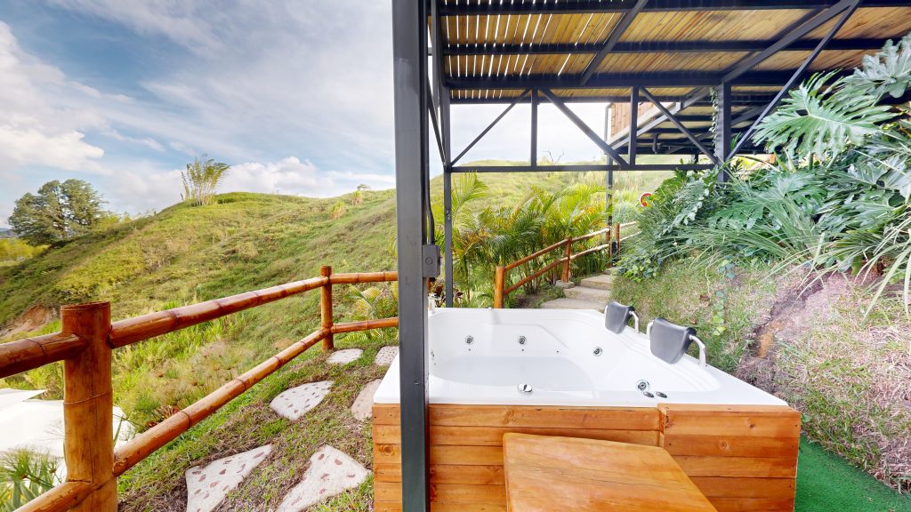 Exterior of the Earth Dome at Bliss Glamping Guatapé with wooden deck